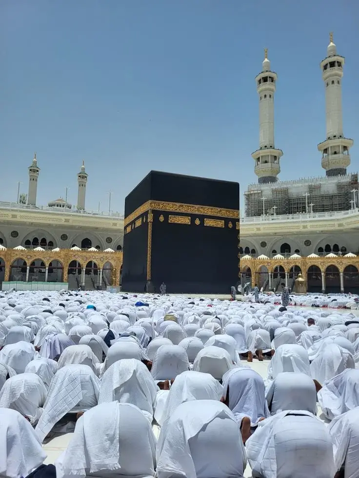 Hajj pilgrims performing prayer in front of the Kaaba at Masjid al-Haram