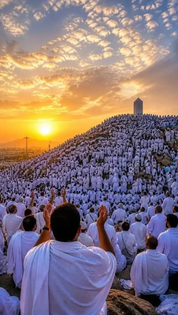 Pilgrims gathered at Jabal al-Rahmah in Arafat during Hajj at sunset
