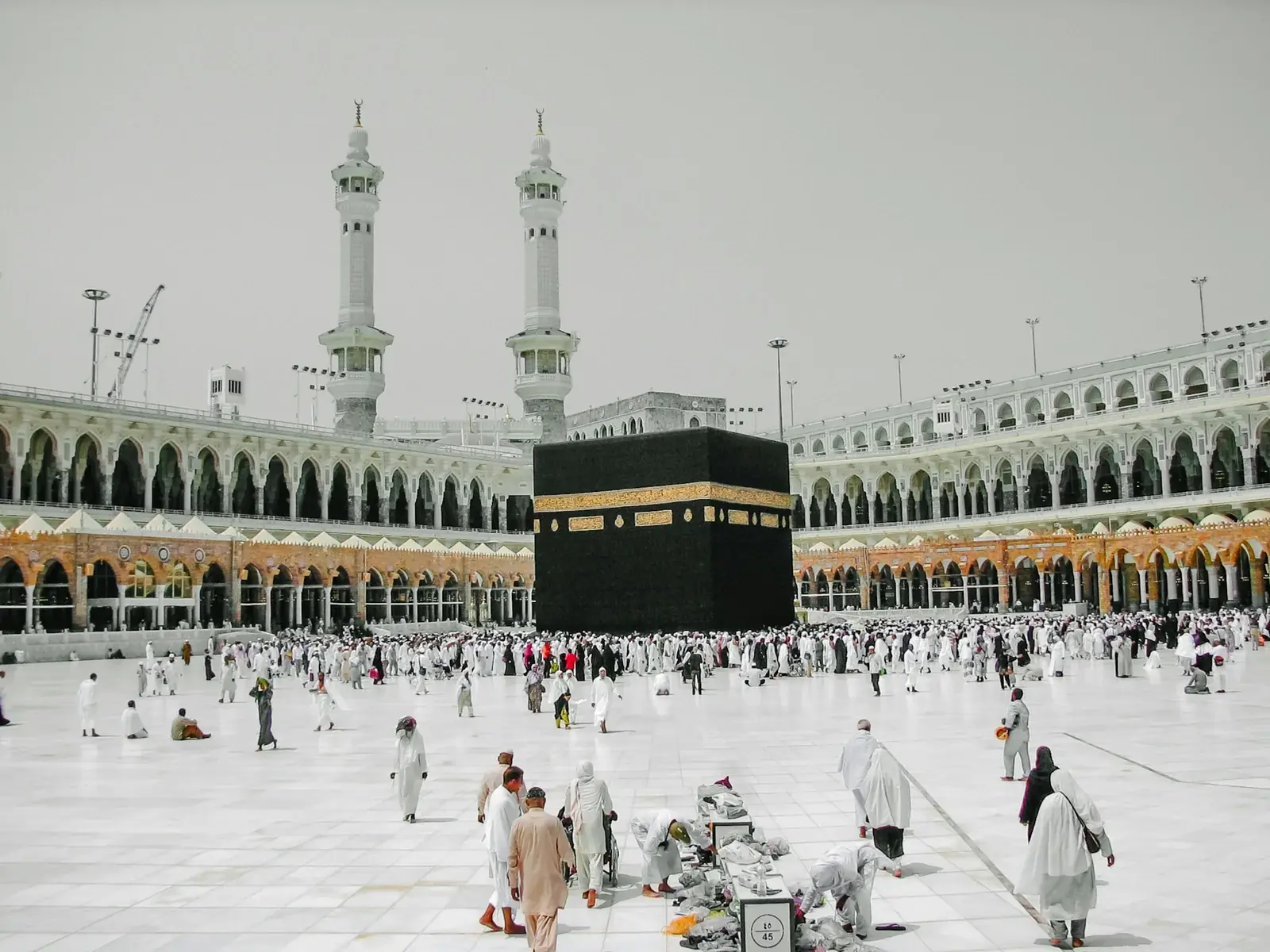 Pilgrims walking near the Kaaba at Masjid al-Haram in Makkah